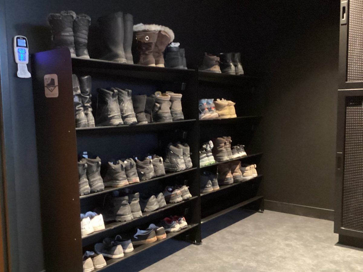 Mur de supports Rakabot remplis de chaussures dans l'entrée d'un bureau